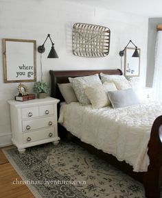 a bedroom with a bed, dresser and window