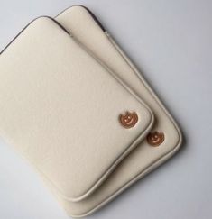 two pieces of white leather with gold buttons