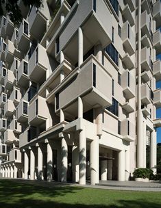 an apartment building with columns and balconies