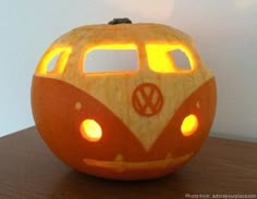 a carved pumpkin shaped like a vw bus with lights on it's side