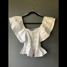 Adorable White Top From Zara Size Small. The Bodice Is Like A Tee Shirt Fabric And Smocked And The Sleeves And Bottom Ruffles Are Cotton. Wear This Off Or On The Shoulders. So Cute And Perfect For Summer. Nwot White Off The Shoulder Top, White Off The Shoulder, White Off Shoulder, Zara White, Off The Shoulder Top, Shirt Fabric, Zara Tops, White Top, White Tops