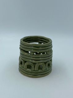 a stack of green rings sitting on top of a white table next to each other