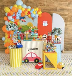 a birthday party with balloons and decorations on the table, including an ice cream stand