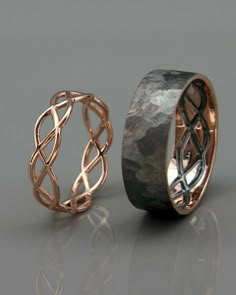 two wedding bands made out of copper and silver rings, one with an intricate design