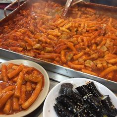 there are many different foods on the table and one is being prepared to be eaten