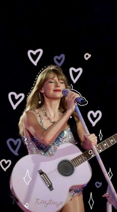 taylor swift singing into a microphone and holding a guitar in front of her with hearts drawn on the background