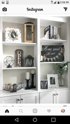 a white book shelf filled with lots of books and pictures on top of each other