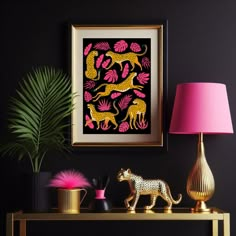 a gold table with a pink lamp next to it and a painting on the wall