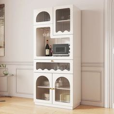 a white cabinet with glass doors in a living room