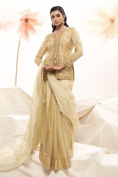 Gold saree with thread, sequin embroidery all over. Paired with full sleeve cutdana, bead, sequin, thread, mirror, zari embroidered padded blouse.
Components: 2
Pattern: Embroidery
Type Of Work: Cutdana, bead, sequin, thread, mirror, zari
Neckline: V neck
Sleeve Type: Full sleeves
Fabric: Rim Zim Zari
Color: Gold
Other Details: 
Approx. Weight: 5-7 kgs
Note: Necklace worn by the model is not for sale
Occasion: Reception - Aza Fashions Saree With Full Sleeve Blouse, Gold Saree, Sequin Saree, Full Sleeve Blouse, Zari Embroidery, Padded Blouse, Sequin Embroidery, Pattern Embroidery, Sequins Embroidery