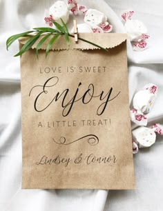 a piece of paper that says love is sweet enjoy at little treat lindsey & connor