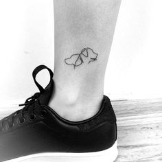 a black and white photo of a person's foot with a tattoo on it