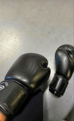 a pair of black boxing gloves sitting on top of a counter