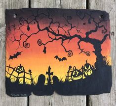 this is an image of a halloween scene painted on a piece of wood with bats and pumpkins