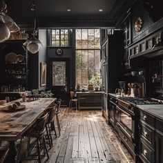 an old fashioned kitchen with wooden floors and black walls, along with lots of windows