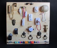 a wooden board with many different types of items attached to the board and hanging on it