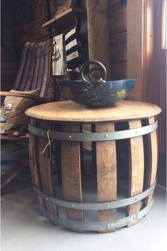 a wooden barrel table with a bowl on top