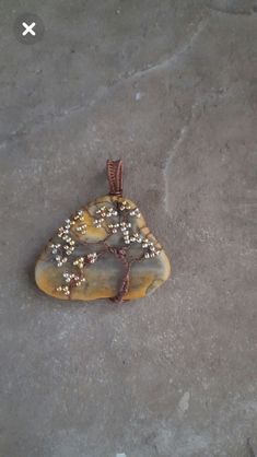 a piece of stone with beads on it