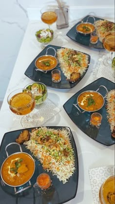 a table topped with plates filled with different types of food on top of each other