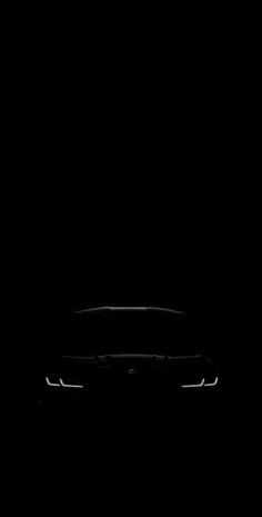 a car is shown in the dark with its headlights on