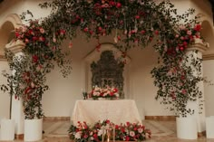 the altar is decorated with flowers and candles