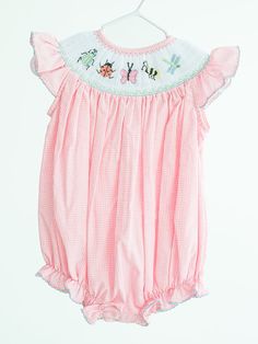 Flutter with delight in our smocked Bugs Birdie Bubble! This charming smocked bubble features an embroidered bug bodice, perfect for your little explorer's spring, and summertime adventures. It allows for freedom of movement during playtime, letting them investigate the wonders of the natural world in comfort and style. - 45% polyester/55% cotton - Available in size NB to 2T - Heirloom quality - Smocked bug-themed bubble Size Guide Looking for more smocked clothes? Take a peek at our smocked dre Easter Egg Embroidery, Egg Embroidery, Libby Dress, Peter Pan Dress, English Dress, Seersucker Skirt, Easter Girl