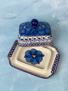 two blue and white dishes sitting on top of each other