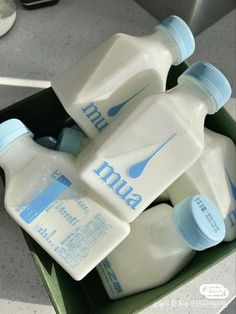 three bottles of milk in a green box