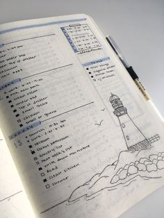 an open notebook with a drawing of a lighthouse on the page and some writing in it