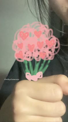 a person holding a bunch of flowers with hearts on the stems in front of their face