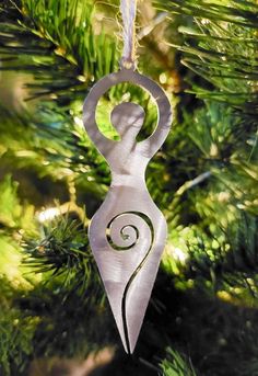 an ornament hanging from a christmas tree in the shape of a female figure