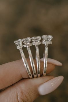 three pieces of diamond ring sitting in the palm of someone's hand with their fingers