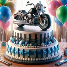 a motorcycle on top of a cake surrounded by balloons