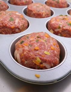 a metal muffin tin filled with meatballs