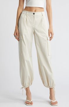 Drawstring ankle-length hems add versatility to these utilitarian cargo pants fashioned with recycled fibers. 28" inseam; 14" leg opening; 11 1/2" front rise; 13 1/2" back rise (size medium) Zip fly with button closure Front slant pockets; cargo flap-patch pockets Drawstring ankle hems 65% recycled polyester, 35% polyester Machine wash, tumble dry Imported Cream Straight Leg Utility Cargo Pants, Cream Wide Leg Cargo Pants, Utility Cotton Cargo Pants With Cuffed Ankles, Beige Cargo Jeans With Cargo Pockets For Spring, Beige Spring Cargo Pants With Multiple Pockets, Beige Cargo Pants With Multiple Pockets For Spring, Spring Beige Cargo Pants With Patch Pockets, Spring Beige Cargo Pants With Multiple Pockets, Beige Cargo Pants With Pockets For Spring