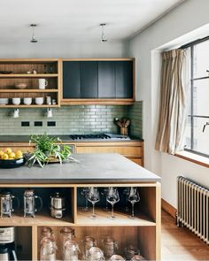 a kitchen with lots of wooden cabinets and counter top space in front of a window