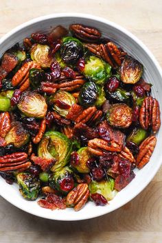 brussel sprouts with pecans and cranberries in a white bowl