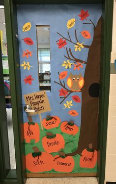 a classroom door decorated with pumpkins and leaves