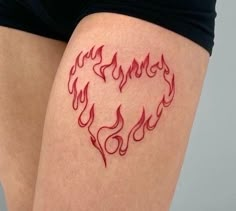 a woman's thigh with red flames drawn on the side of her leg and in the shape of a heart