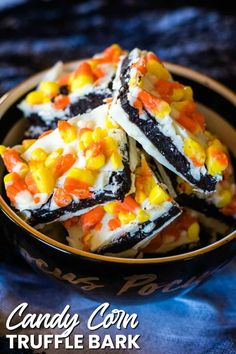 several pieces of cake with candy corn on top in a brown and black bowl,