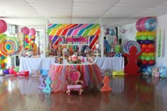 a room filled with lots of colorful balloons and decorations