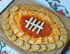 a football shaped cheese and cracker platter