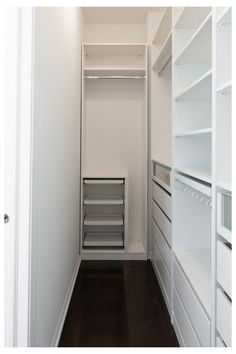 an empty walk in closet with shelves and drawers