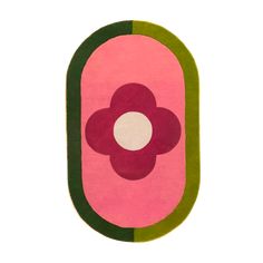 a pink and green rug with a flower in the center on a white background,