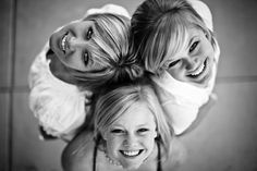 three girls are posing for the camera in black and white