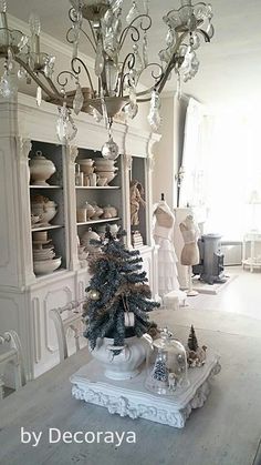 a christmas tree is in the middle of a room with many other ornaments on it