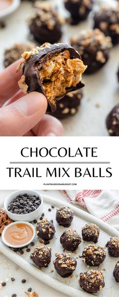 chocolate trail mix balls are being held up by someone's hand and on a tray