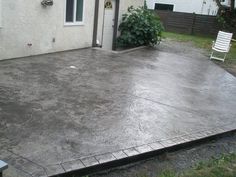 a concrete patio in front of a house