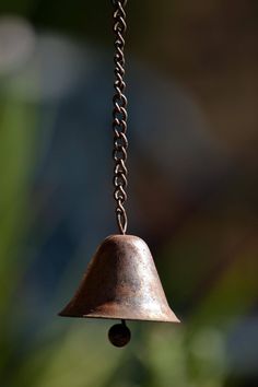 an old bell hanging from a chain