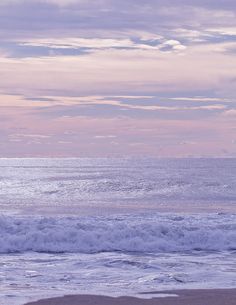 two surfers carrying their boards out to the ocean